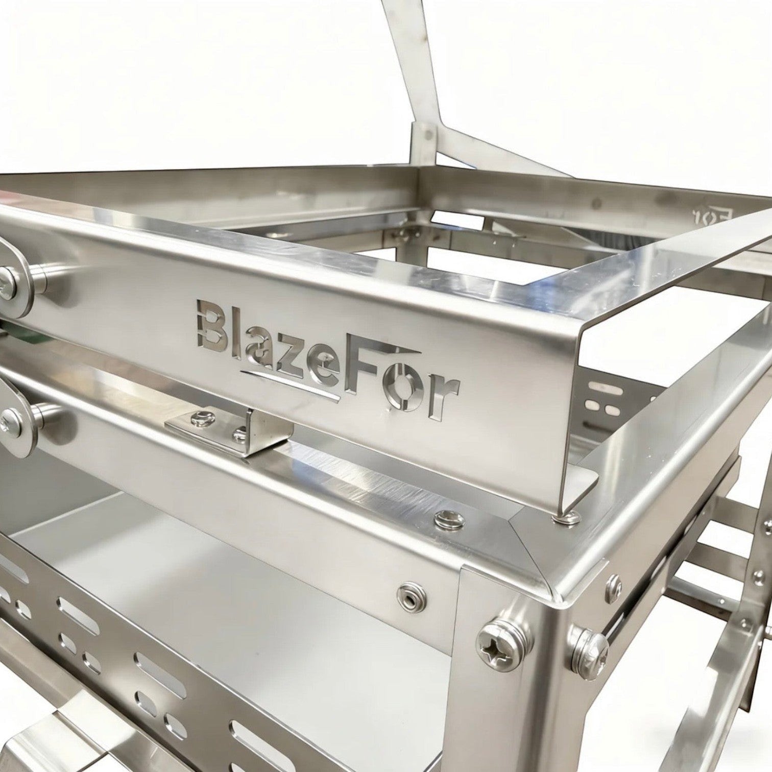 BBQ FIRE stainless steel rotisserie barbecue with adjustable charcoal height and integrated BlazeFor logo.